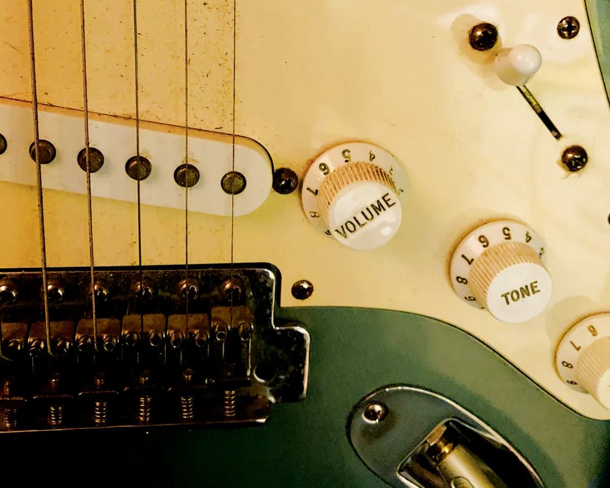 Closeup of green, made-in-Mexico Fender Stratocaster electric guitar