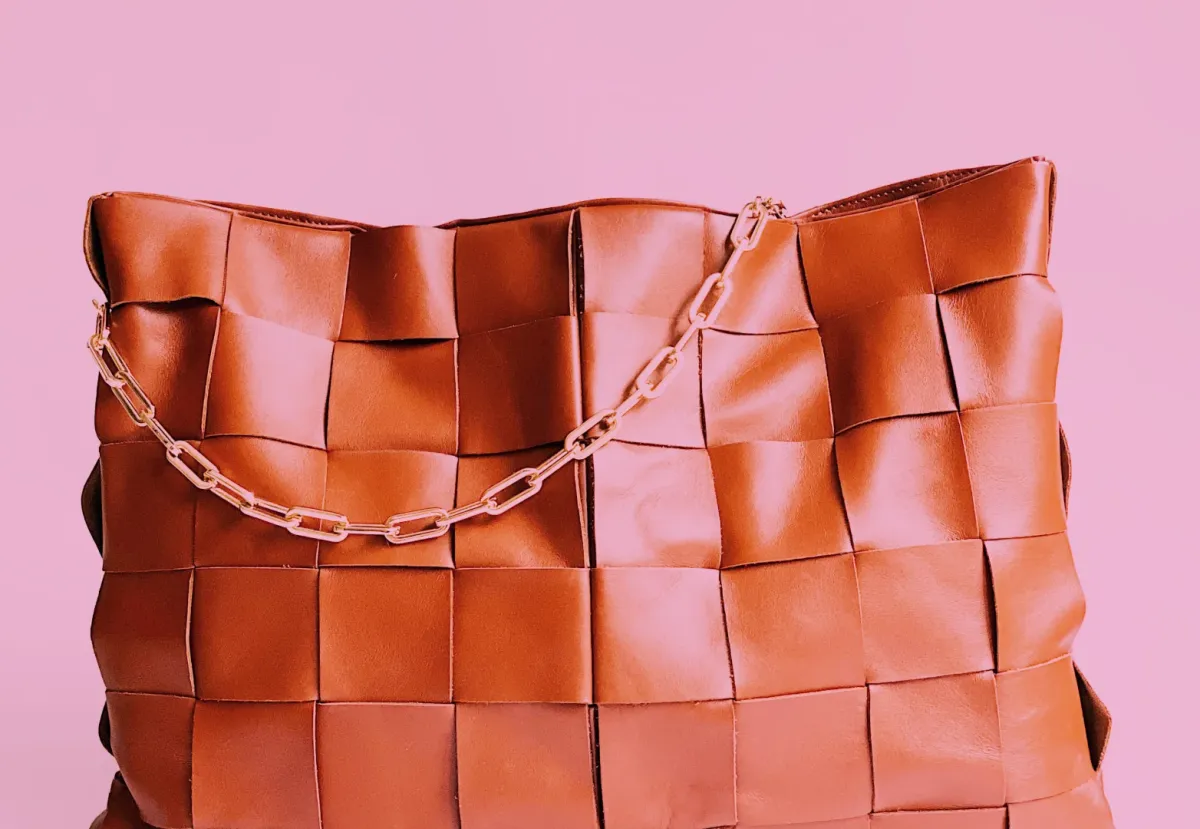 A 1970s style woven leather handbag with gold chain strap